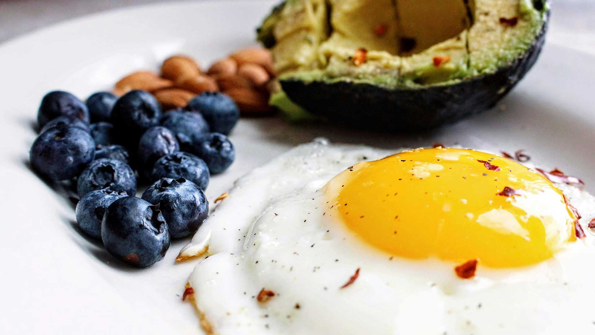 healthy meal consisting of: avocados, blueberries, eggs in a healthy restaurant